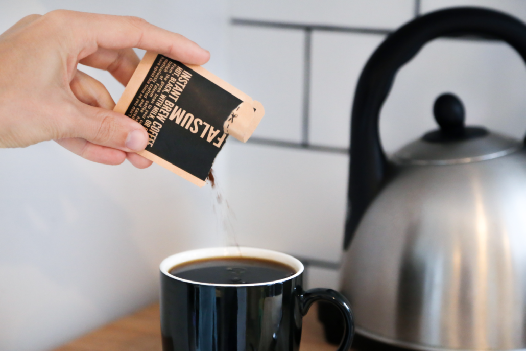Falsum instant brew pouring out of a sachet into a cup